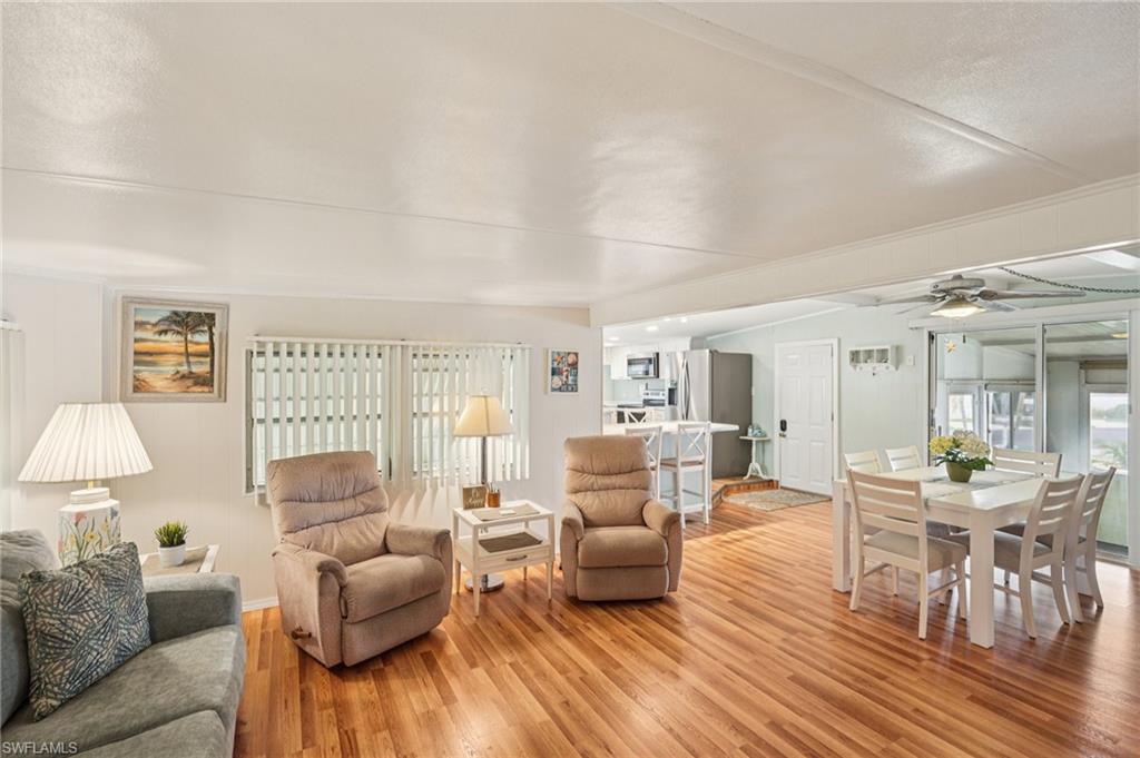 104 Willow Lane, Unit 30 Naples, FL 34114 - Photo 2 of 30 Living room featuring light wood-style flooring and a ceiling fan