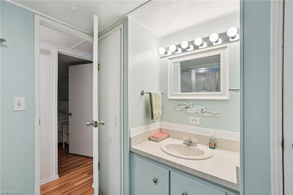 104 Willow Lane, Unit 30 Naples, FL 34114 - Photo 21 of 30 Bathroom with vanity and wood finished floors