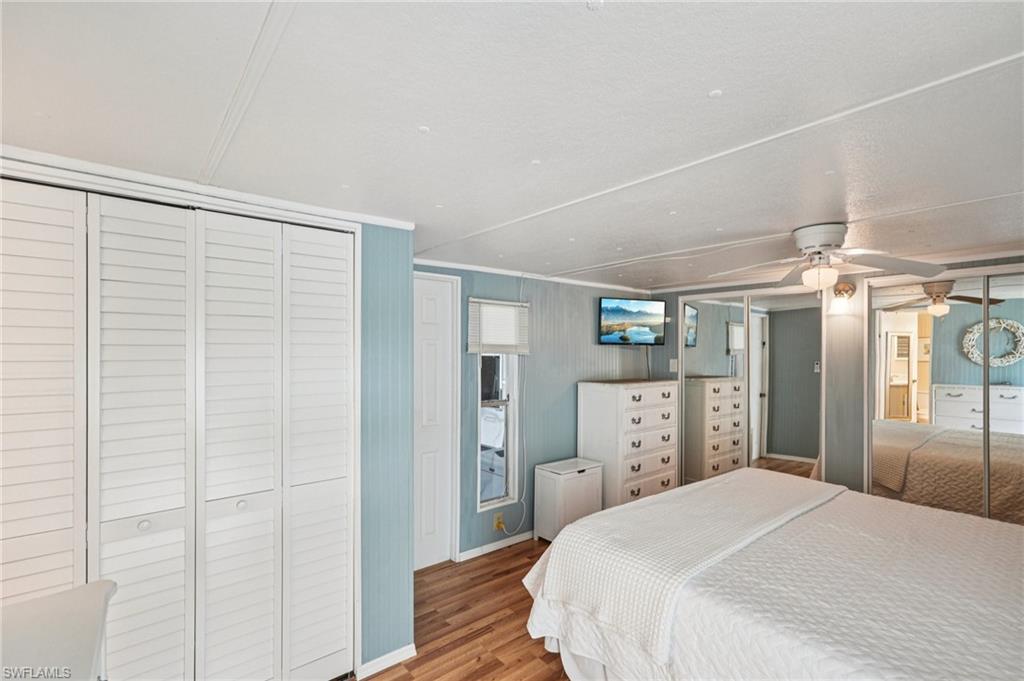 104 Willow Lane, Unit 30 Naples, FL 34114 - Photo 23 of 30 Bedroom with wood finished floors, a closet, and ceiling fan