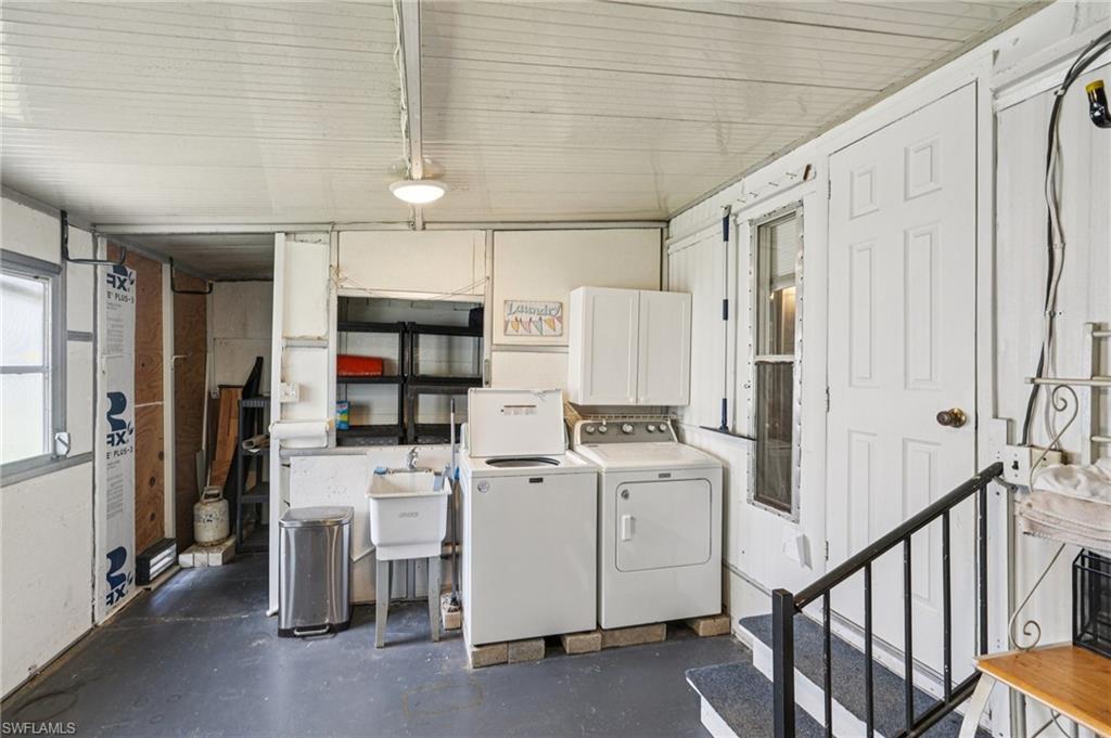 104 Willow Lane, Unit 30 Naples, FL 34114 - Photo 26 of 30 Washroom featuring independent washer and dryer and cabinet space