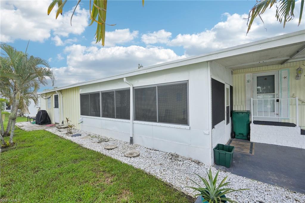 104 Willow Lane, Unit 30 Naples, FL 34114 - Photo 6 of 30 View of side of property featuring a yard