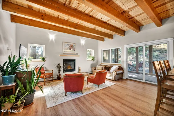 a dining room with furniture and wooden floor