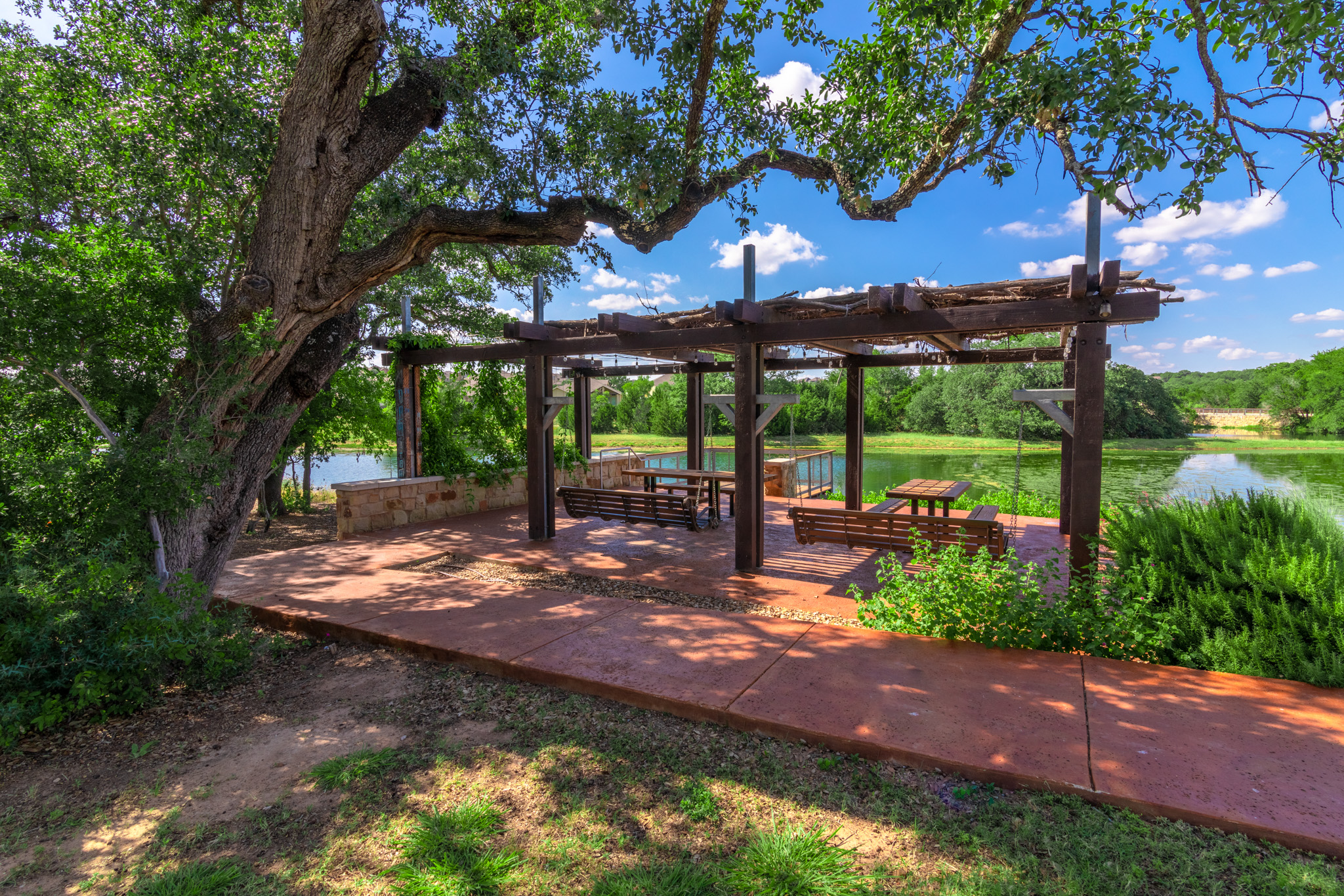 132 Vino Rossi Road Georgetown, TX 78628 - Photo 32 of 35 Yes another Arbor with porch swings overlooking natural spring ponds that flow through outdoors