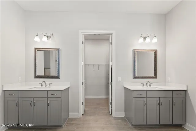 a bathroom with double vanity sink two mirror and a