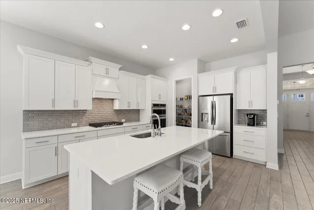 a kitchen with stainless steel appliances a refrigerator stove microwave and cabinets