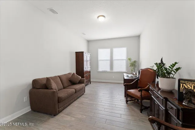 a living room with furniture and a window