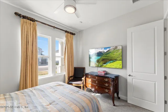 a bedroom with a bed and a flat tv screen