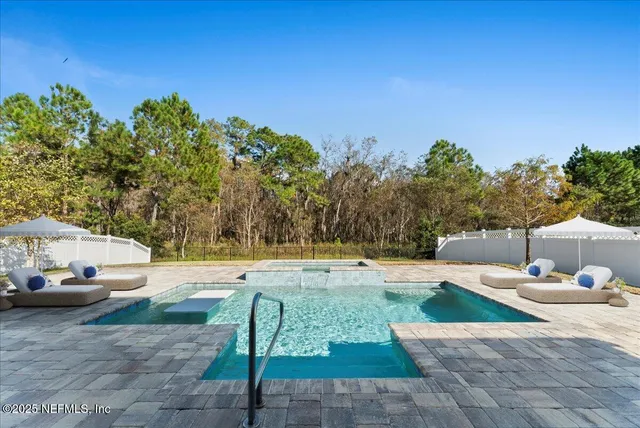 a view of a swimming pool and lounge chairs