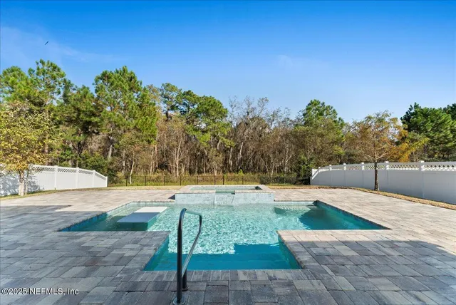 a view of a swimming pool with an outdoor space and seating area