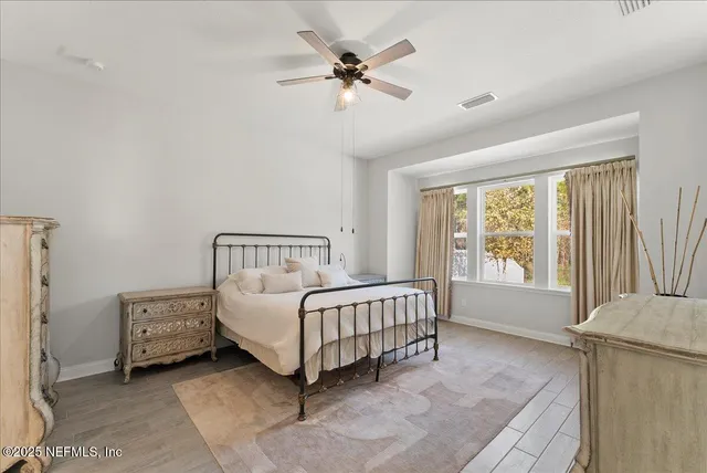 a spacious bedroom with a bed and a window