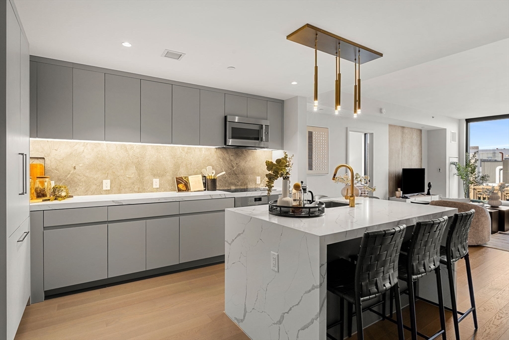 a kitchen with a sink dining table and chairs