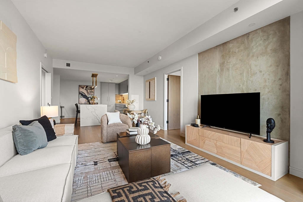 55 Lagrange Street, Unit 1703 Boston, MA 02111 - Photo 11 of 33 a living room with furniture and a flat screen tv