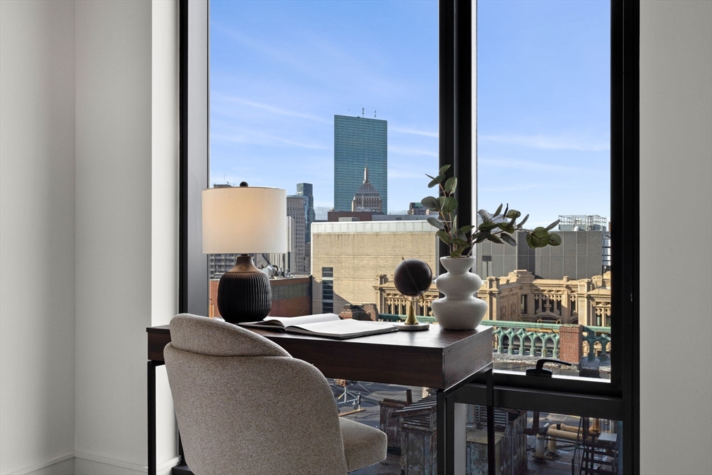 55 Lagrange Street, Unit 1703 Boston, MA 02111 - Photo 18 of 33 a dining room with furniture and a floor to ceiling window