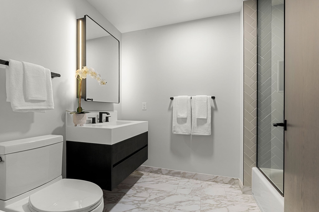 55 Lagrange Street, Unit 1703 Boston, MA 02111 - Photo 20 of 33 a bathroom with a sink toilet and shower