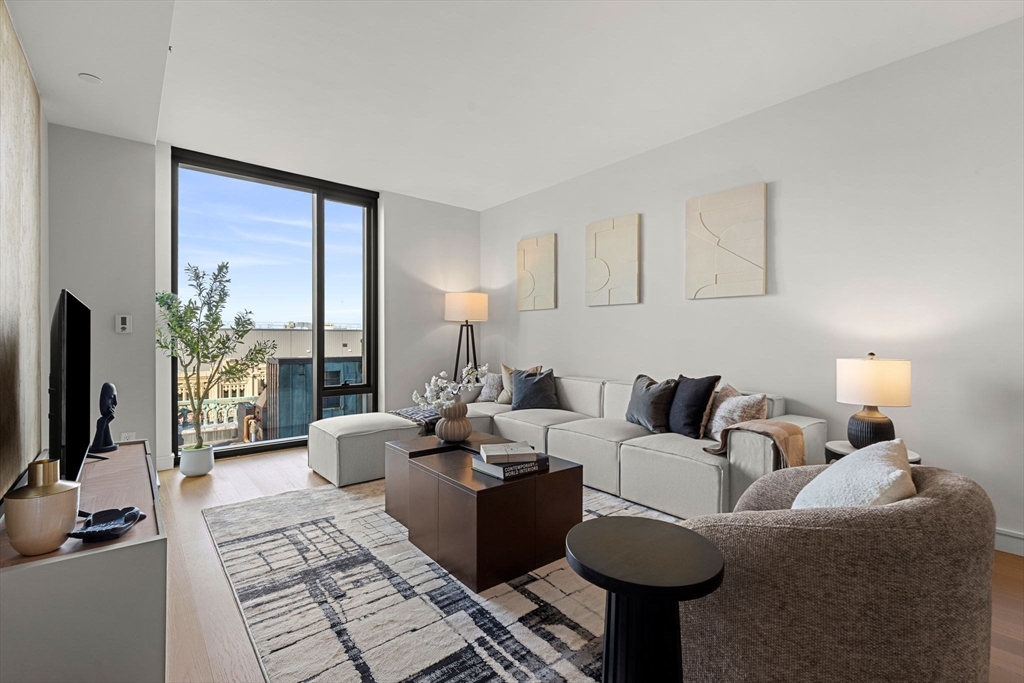 55 Lagrange Street, Unit 1703 Boston, MA 02111 - Photo 2 of 33 a living room with furniture and a flat screen tv