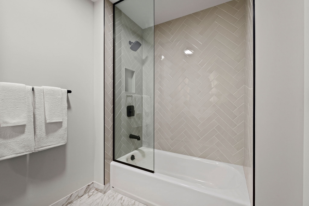 55 Lagrange Street, Unit 1703 Boston, MA 02111 - Photo 21 of 33 a bathroom with a shower and a bathtub
