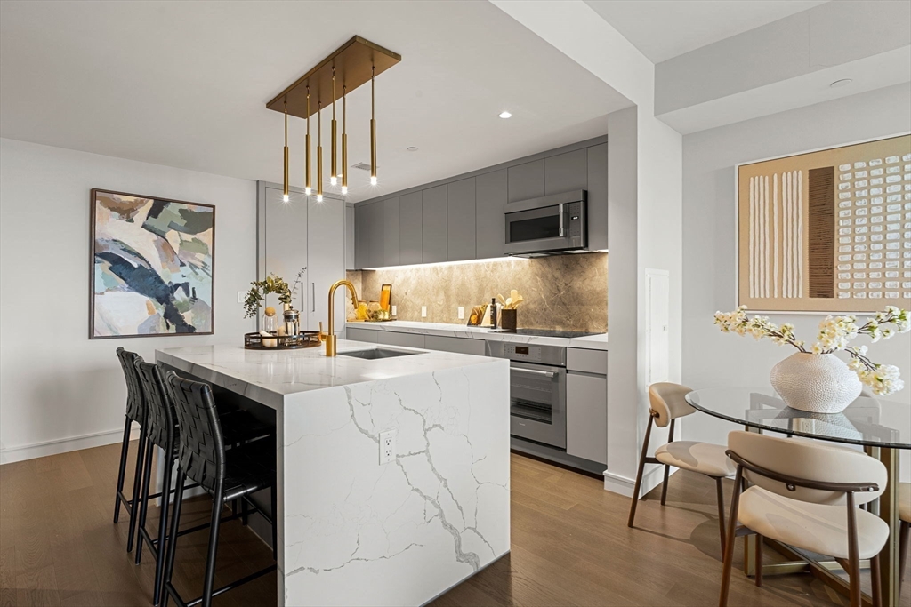 55 Lagrange Street, Unit 1703 Boston, MA 02111 - Photo 4 of 33 a kitchen with a dining table and chairs