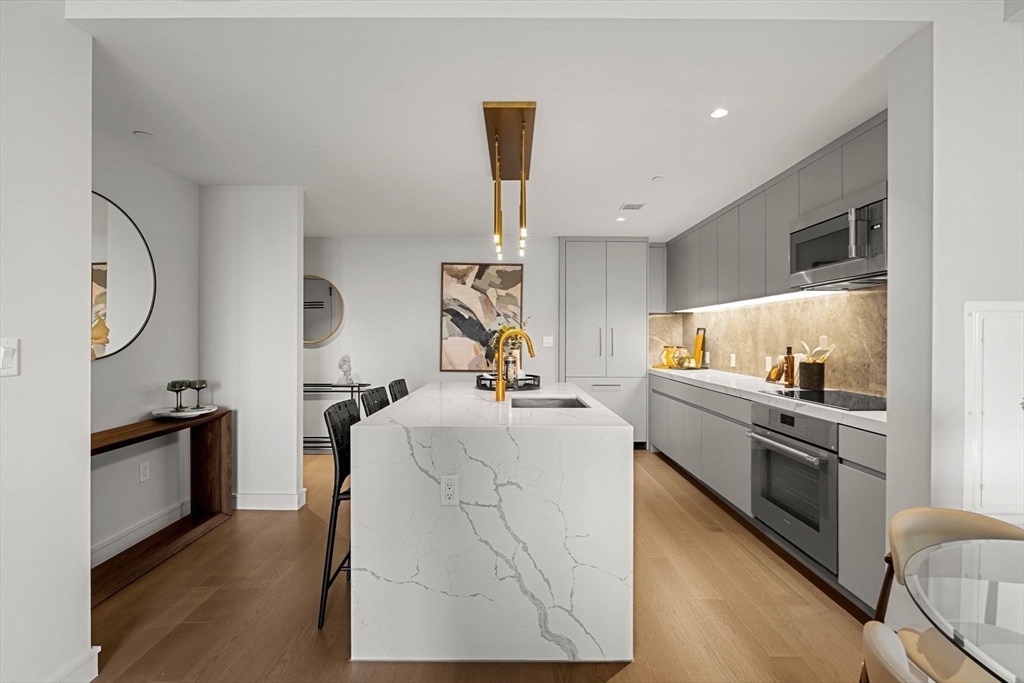 55 Lagrange Street, Unit 1703 Boston, MA 02111 - Photo 6 of 33 a kitchen with granite countertop a refrigerator stove and sink