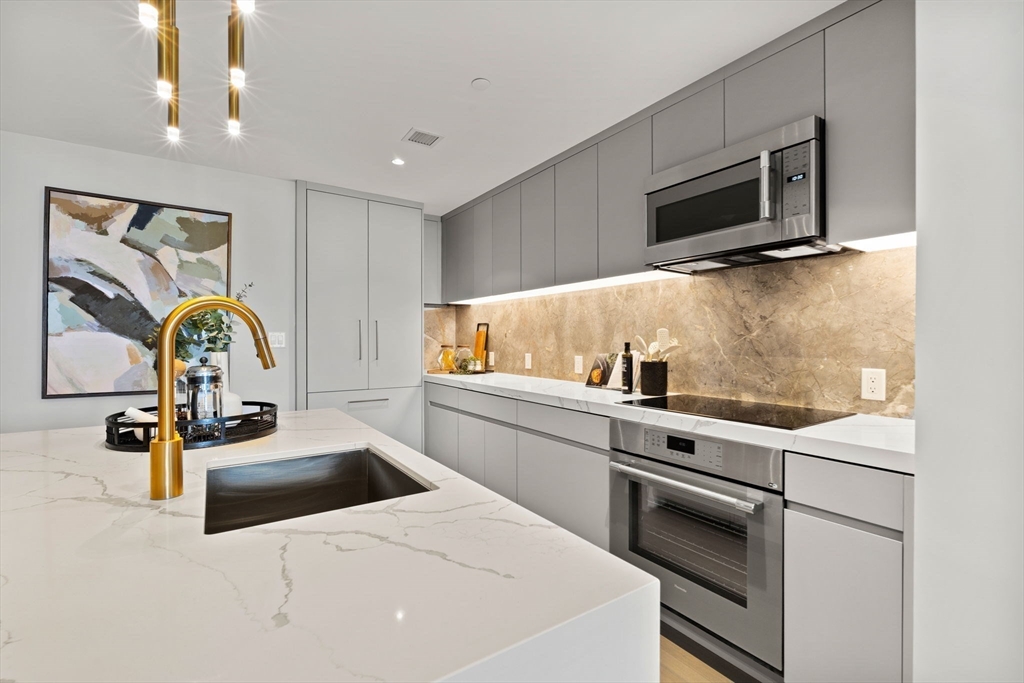55 Lagrange Street, Unit 1703 Boston, MA 02111 - Photo 9 of 33 a kitchen with a sink appliances and cabinets