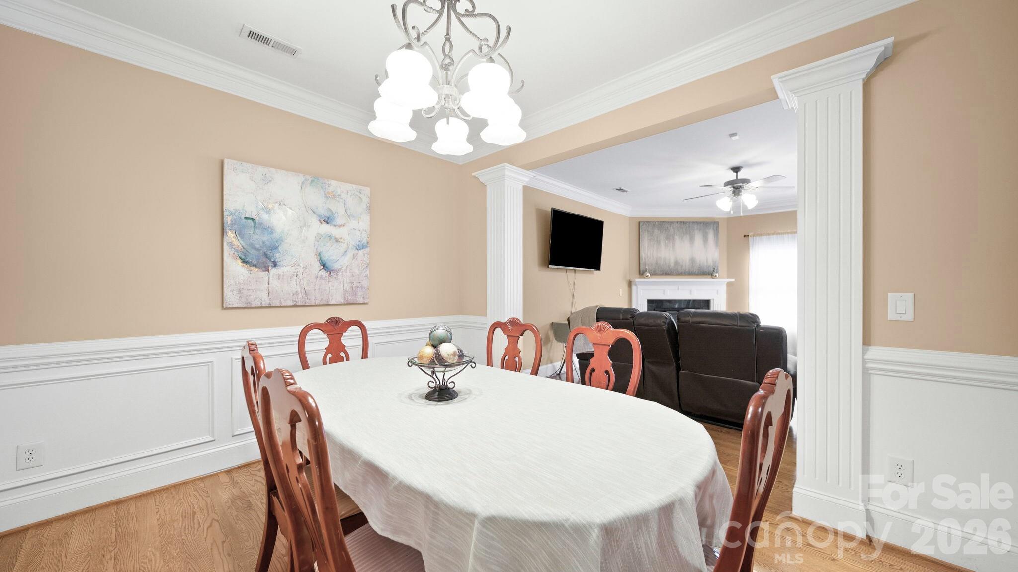 804 Talking Stick Lane Fort Mill, SC 29708 - Photo 13 of 34 a view of a dining room with furniture a chandelier and wooden floor