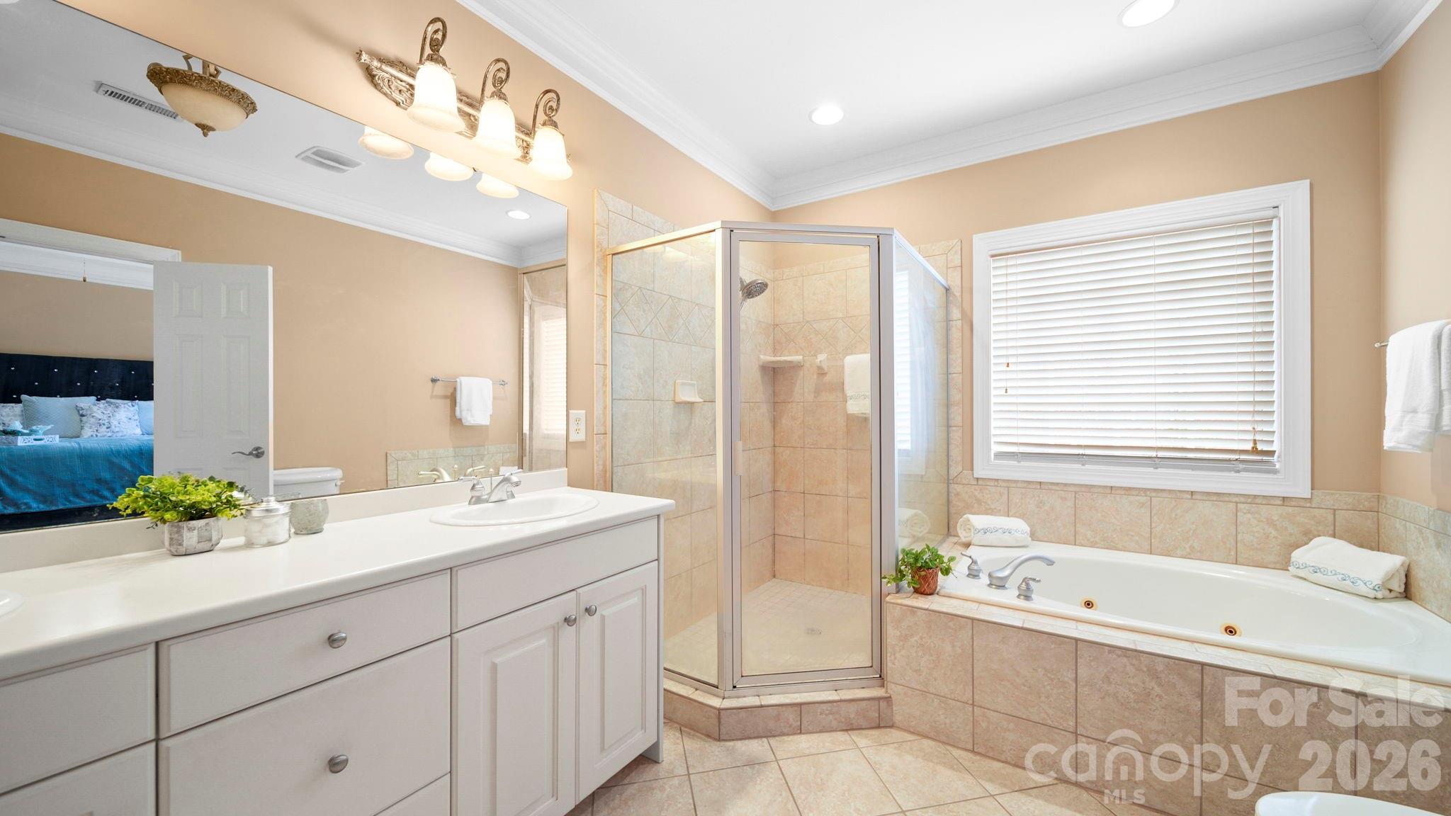 804 Talking Stick Lane Fort Mill, SC 29708 - Photo 18 of 34 a spacious bathroom with a double vanity sink a large mirror and a bathtub