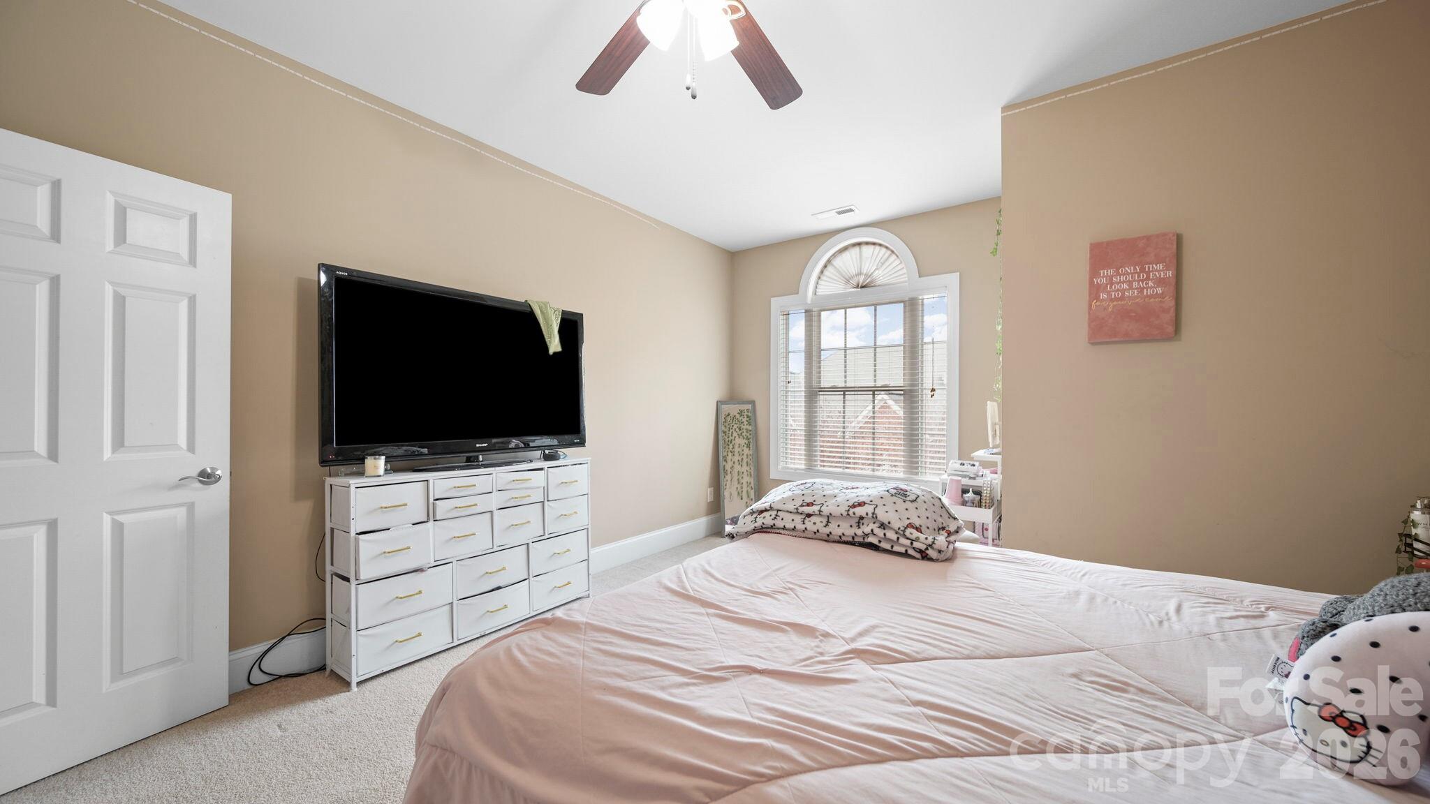 804 Talking Stick Lane Fort Mill, SC 29708 - Photo 22 of 34 a bedroom with a bed and a flat screen tv
