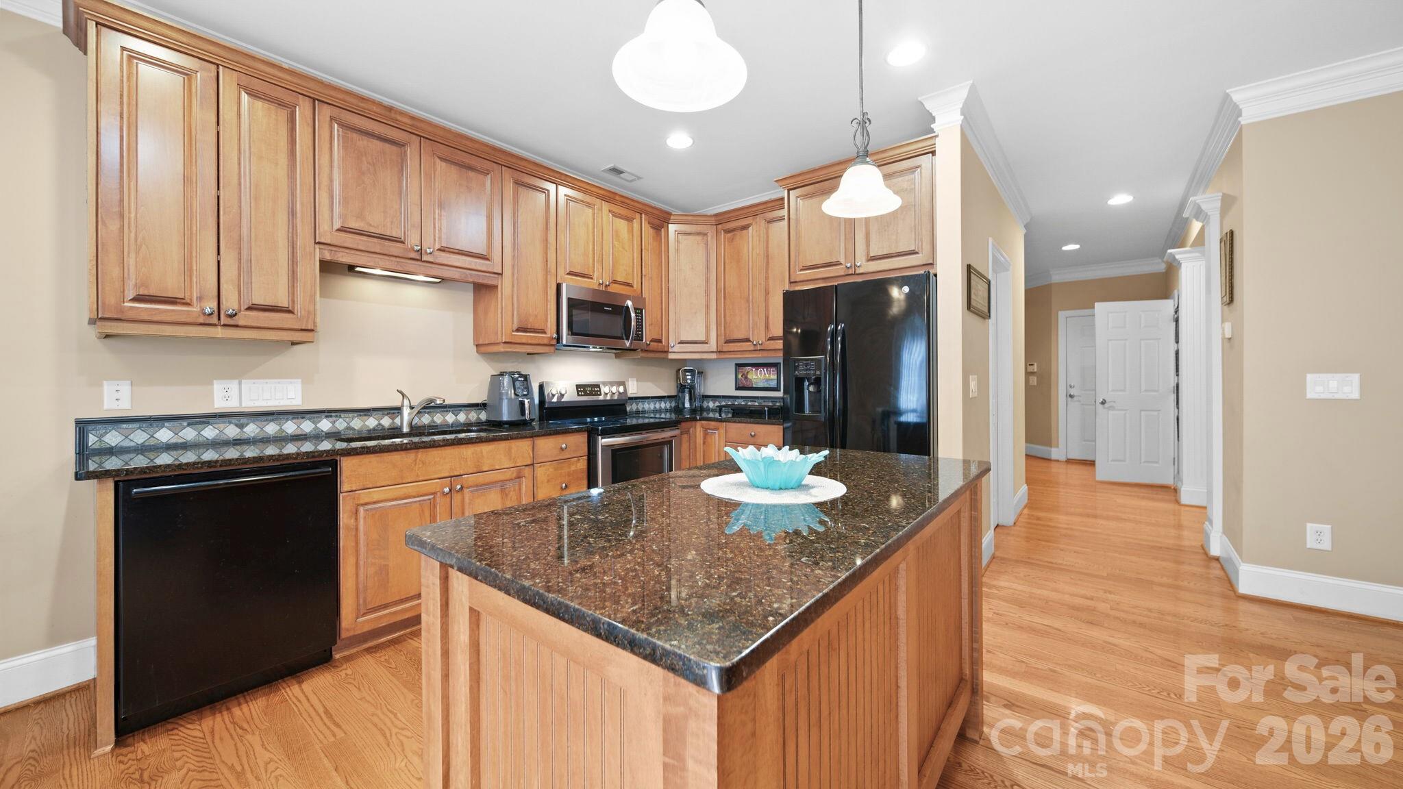 804 Talking Stick Lane Fort Mill, SC 29708 - Photo 4 of 34 a kitchen with granite countertop kitchen island stainless steel appliances a sink stove and refrigerator