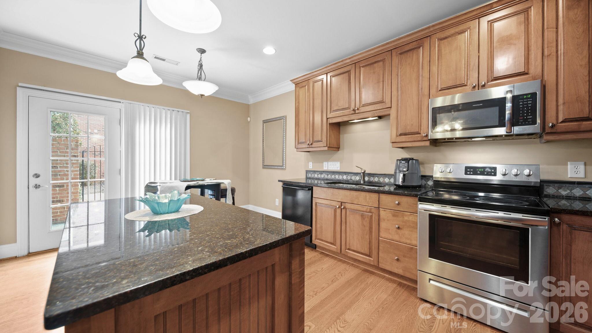 804 Talking Stick Lane Fort Mill, SC 29708 - Photo 8 of 34 a kitchen with stainless steel appliances granite countertop a stove a sink and a microwave