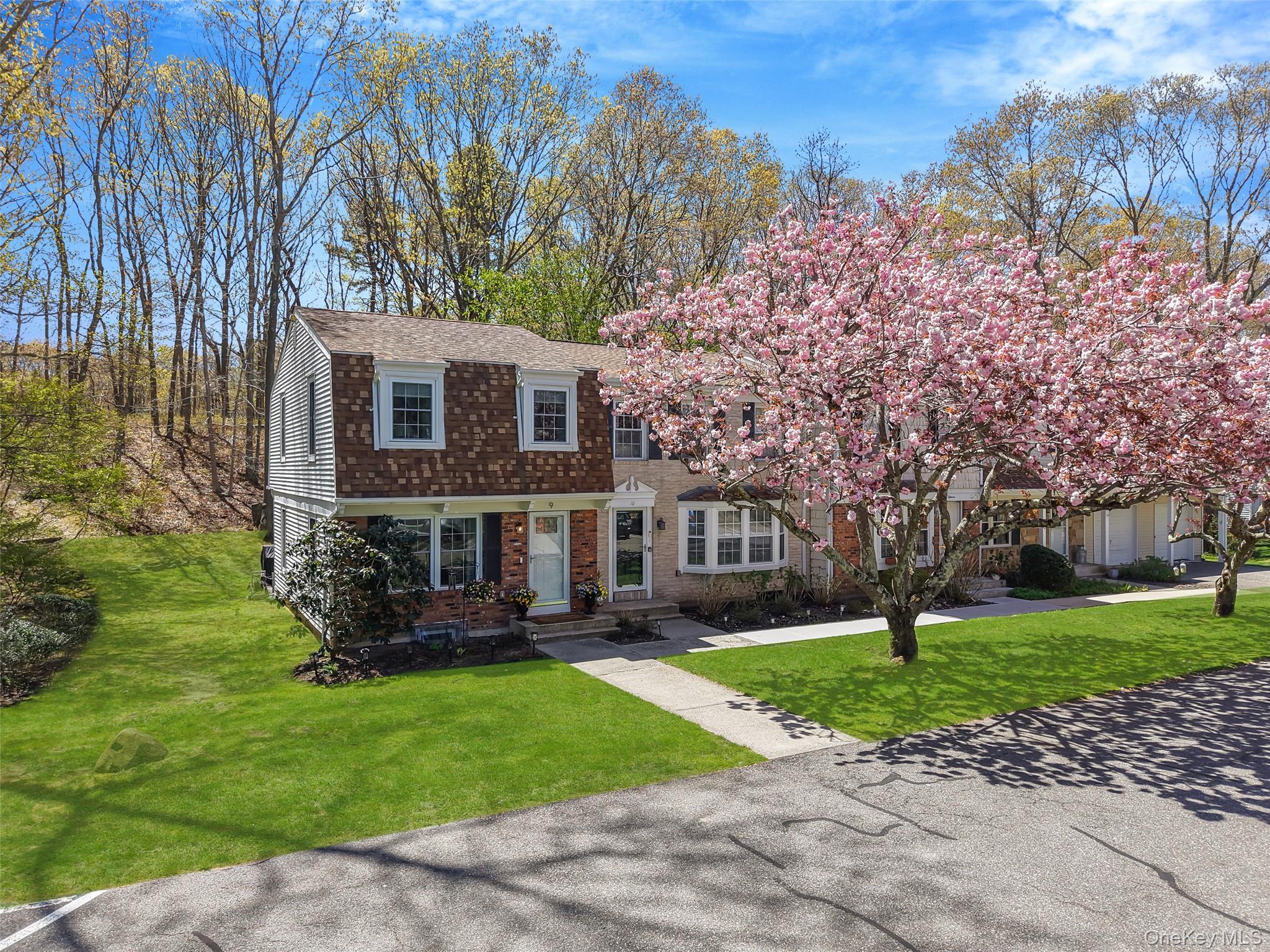 9 Penn Commons Yaphank, NY 11980 - Photo 1 of 34 a front view of a house with garden