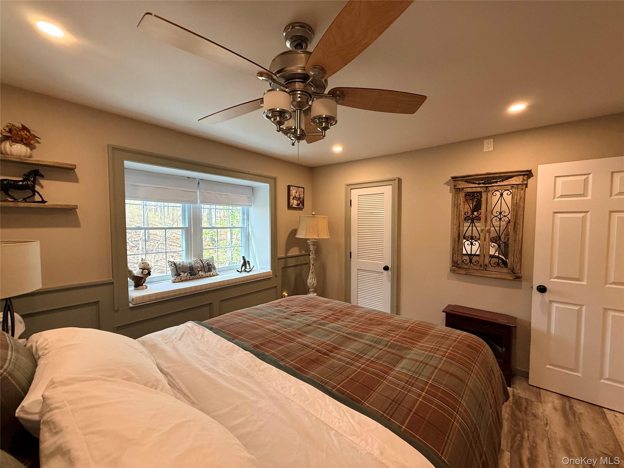 9 Penn Commons Yaphank, NY 11980 - Photo 18 of 34 a bedroom with a large bed and a chandelier