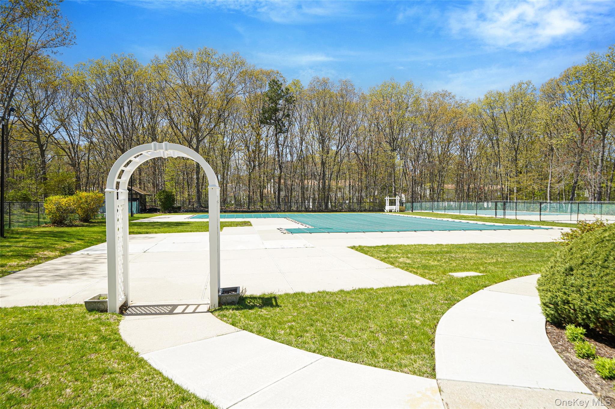 9 Penn Commons Yaphank, NY 11980 - Photo 27 of 34 a view of a swimming pool with a yard