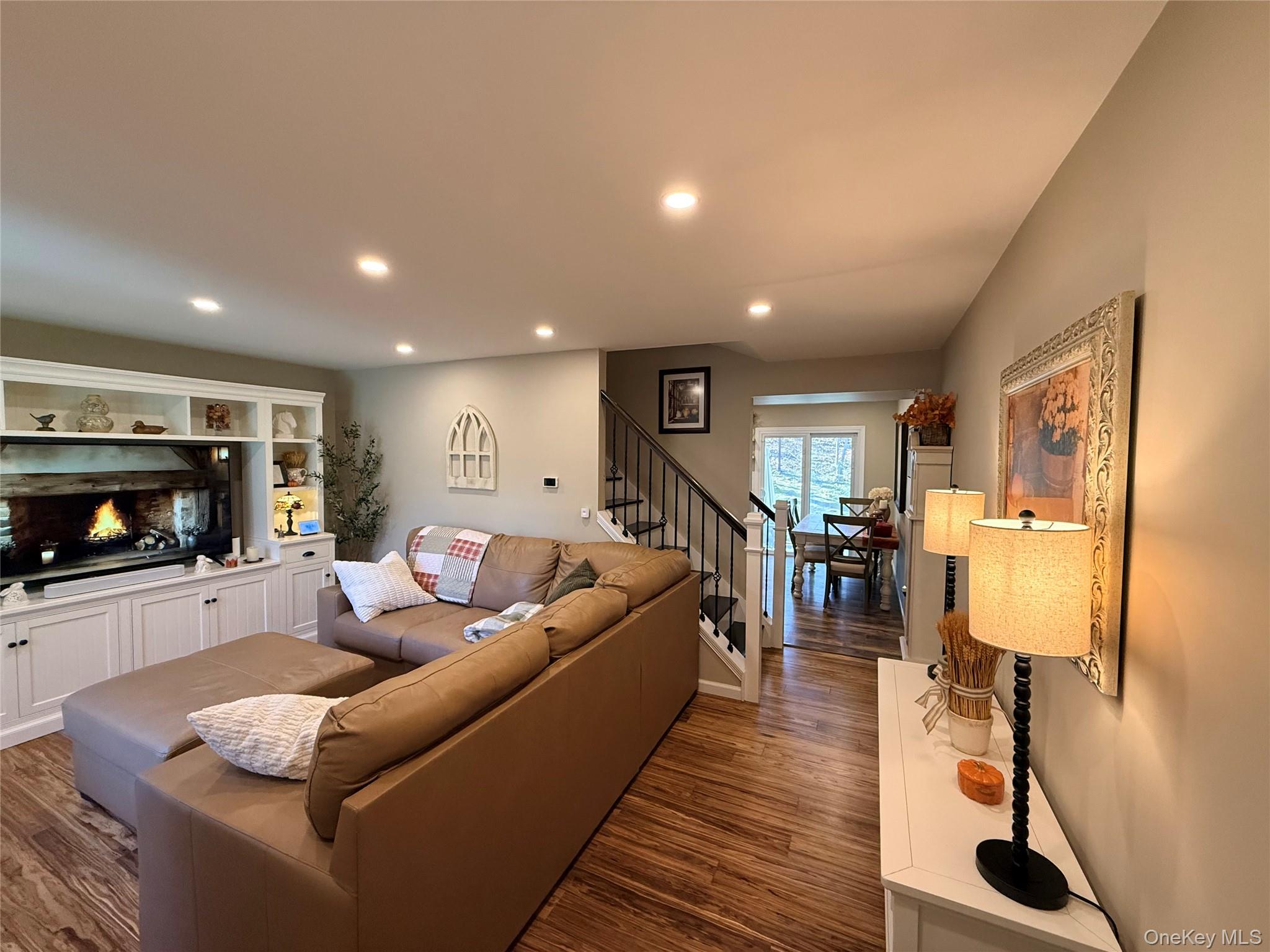 9 Penn Commons Yaphank, NY 11980 - Photo 8 of 34 a living room with furniture and a fireplace