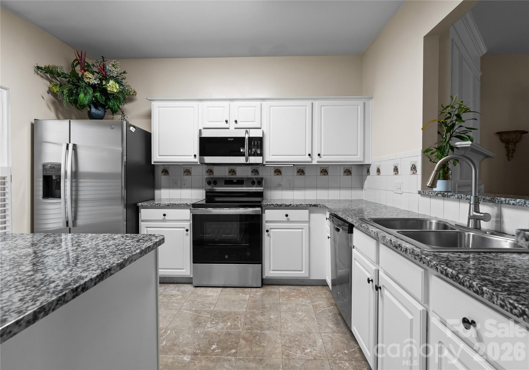 6776 Rothchild Drive Charlotte, NC 28270 - Photo 14 of 40 a kitchen with kitchen island granite countertop a sink stove and refrigerator