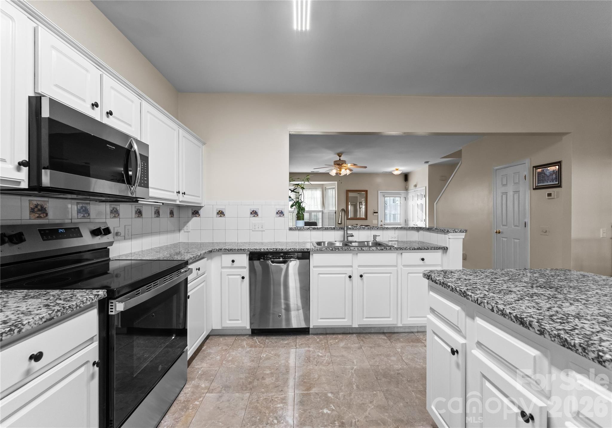 6776 Rothchild Drive Charlotte, NC 28270 - Photo 15 of 40 a kitchen with a sink stove and microwave