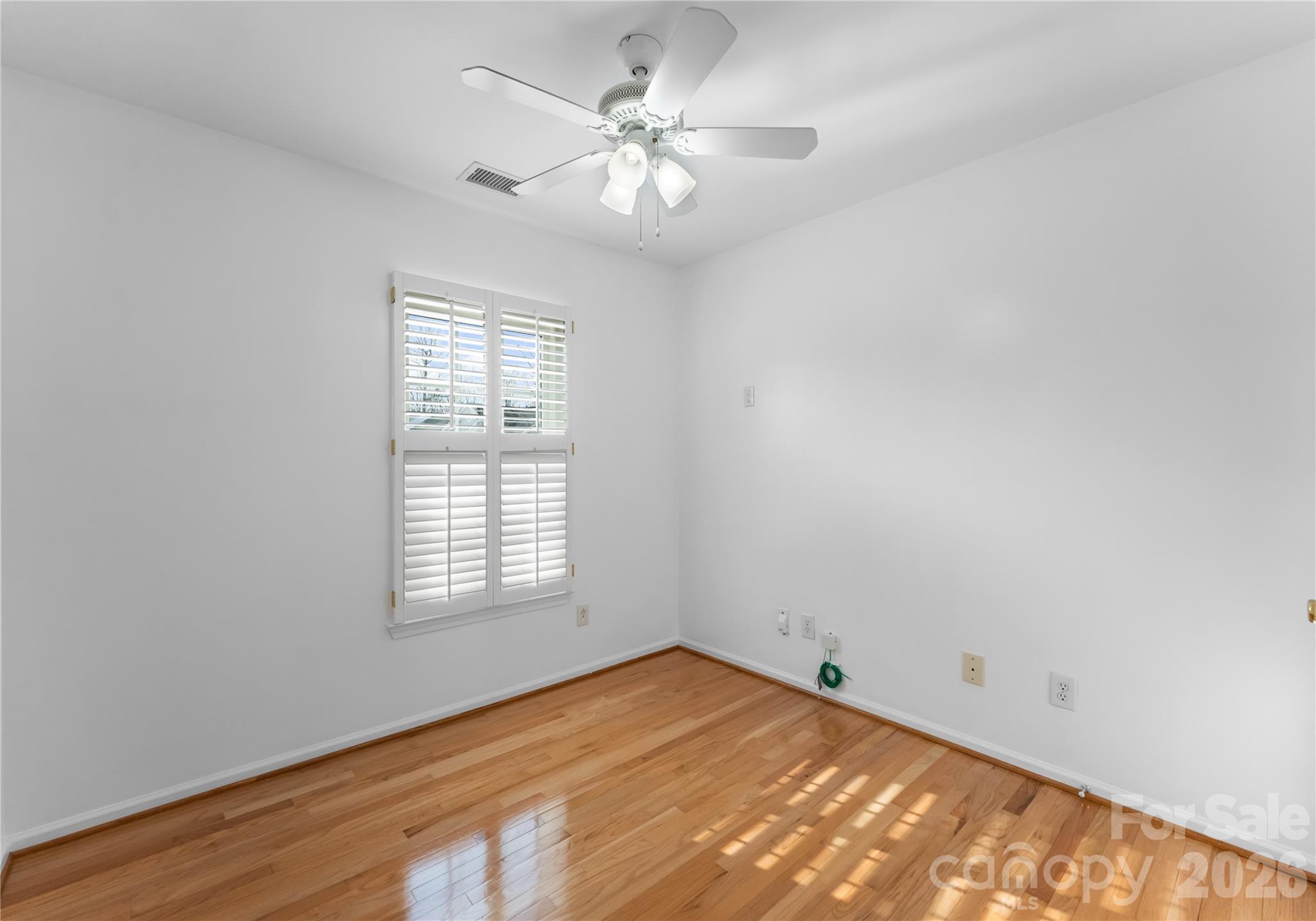 6776 Rothchild Drive Charlotte, NC 28270 - Photo 25 of 40 wooden floor in an empty room with a window