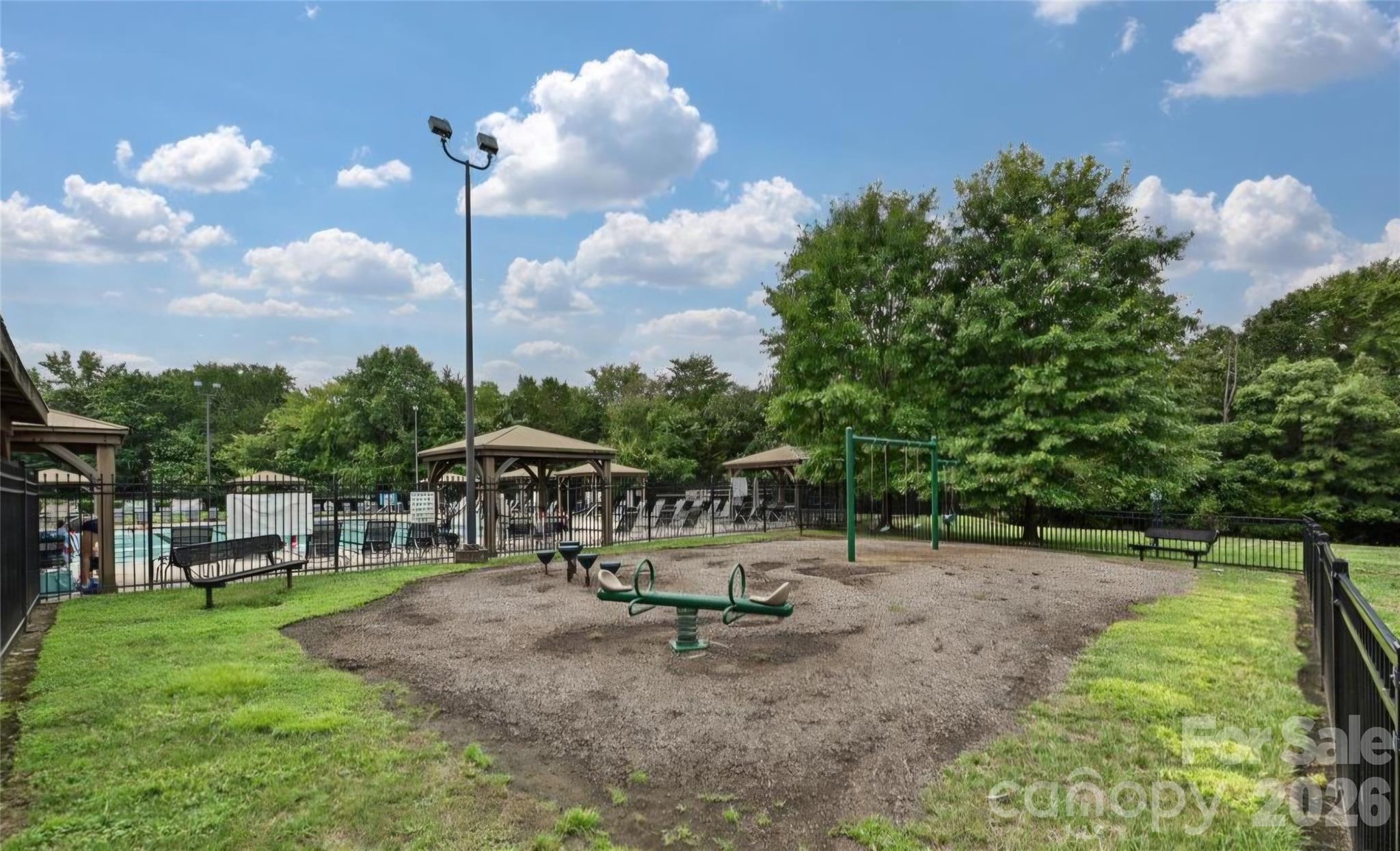 6776 Rothchild Drive Charlotte, NC 28270 - Photo 38 of 40 a swimming pool with outdoor seating and garden