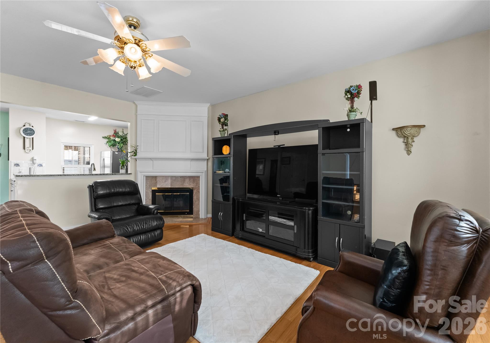 6776 Rothchild Drive Charlotte, NC 28270 - Photo 6 of 40 a bedroom with furniture a flat screen tv and a fireplace