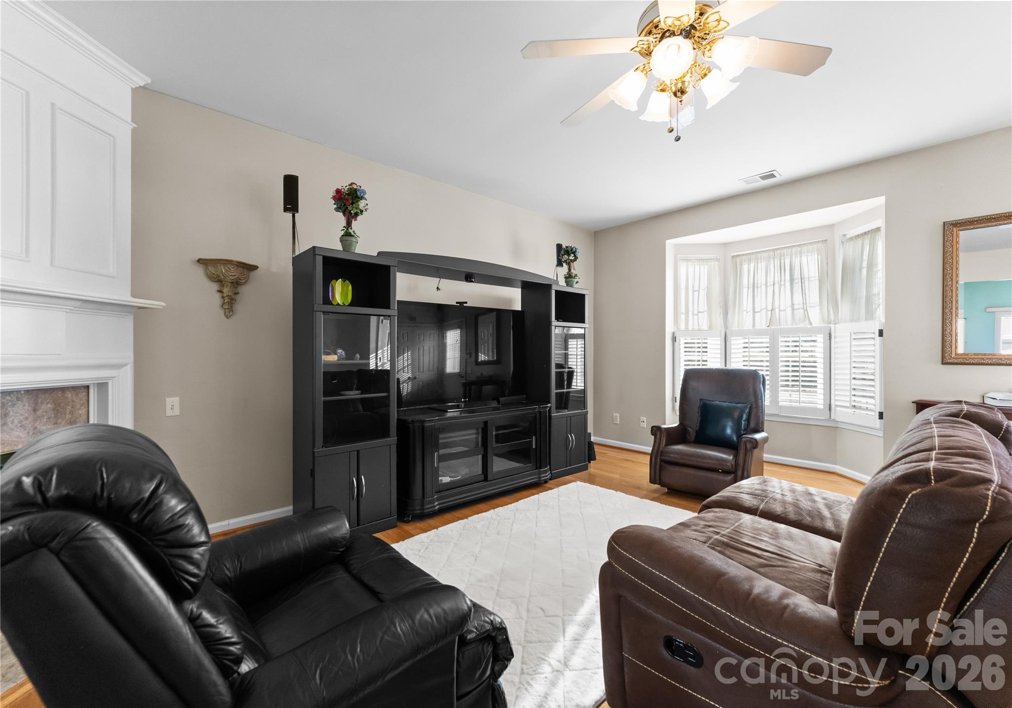 6776 Rothchild Drive Charlotte, NC 28270 - Photo 9 of 40 a living room with furniture a flat screen tv and a chandelier