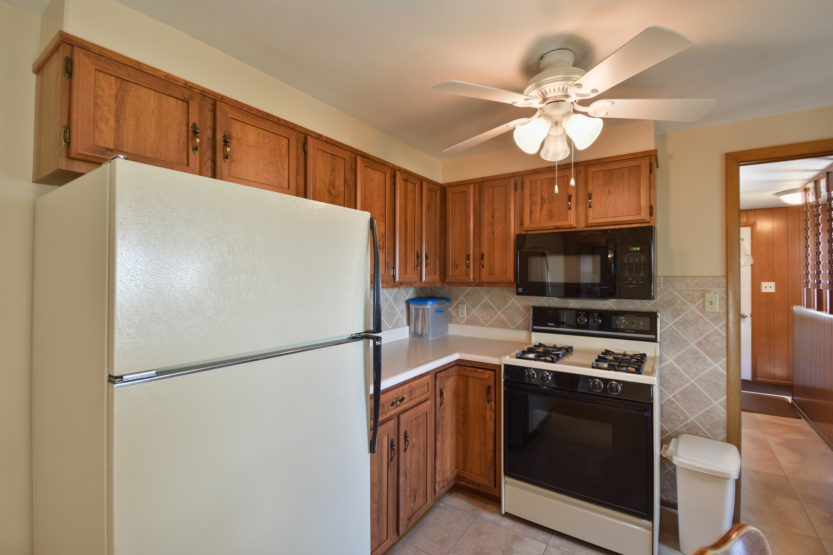 1542 East 18th Road Streator, IL 61364 - Photo 11 of 47 a white refrigerator freezer and a stove sitting inside of a kitchen