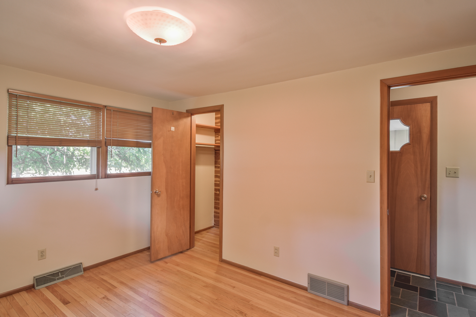 1542 East 18th Road Streator, IL 61364 - Photo 22 of 47 an empty room with wooden floor and windows