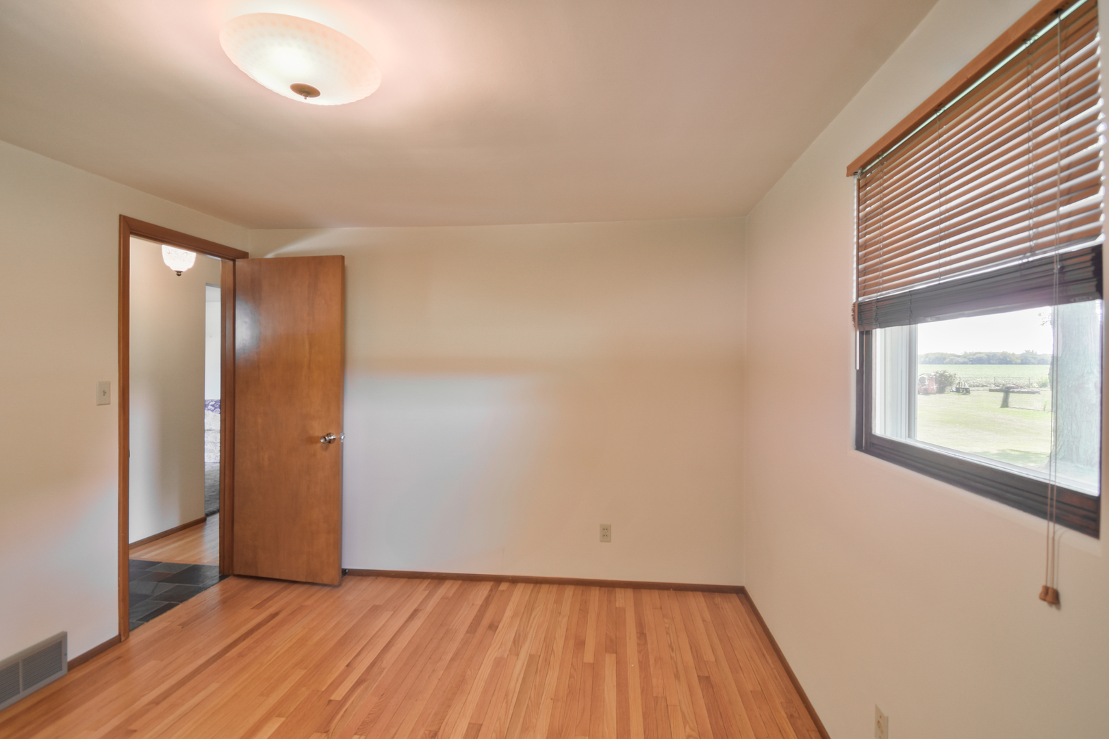 1542 East 18th Road Streator, IL 61364 - Photo 24 of 47 a view of a room with wooden floor and a window