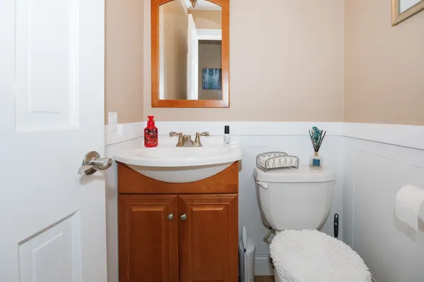 a bathroom with a toilet sink and mirror