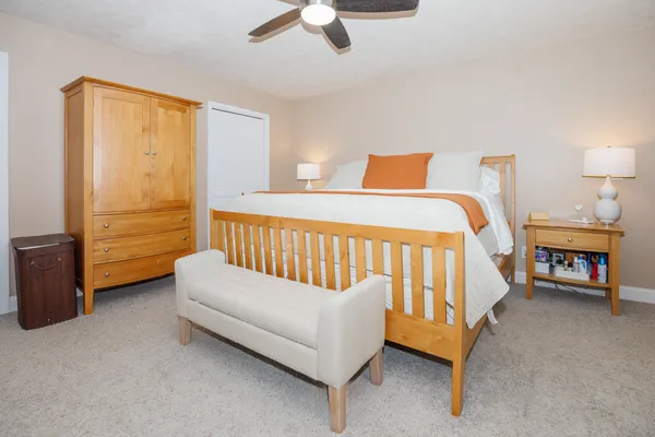 a bedroom with a bed and a chandelier