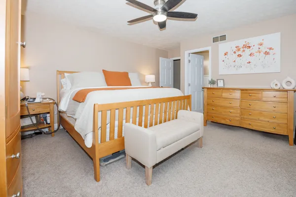 a bedroom with a bed and a baby bed
