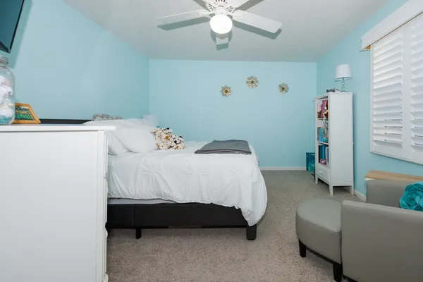 a bedroom with a bed dresser and a couch