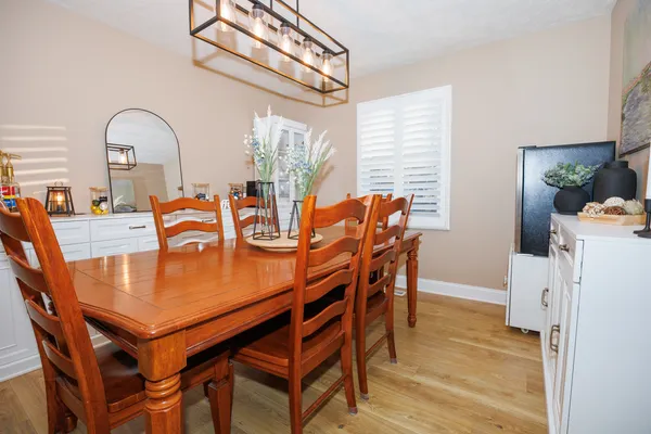 a dining room with furniture and wooden floor