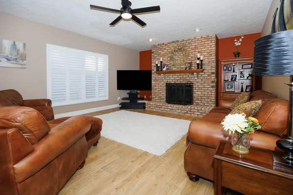 a living room with furniture a fireplace and a flat screen tv