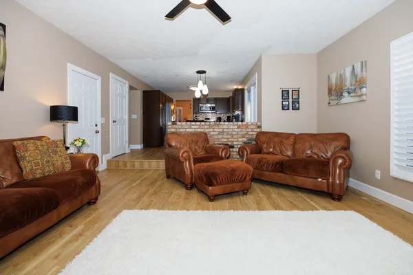 a living room with furniture and a chandelier