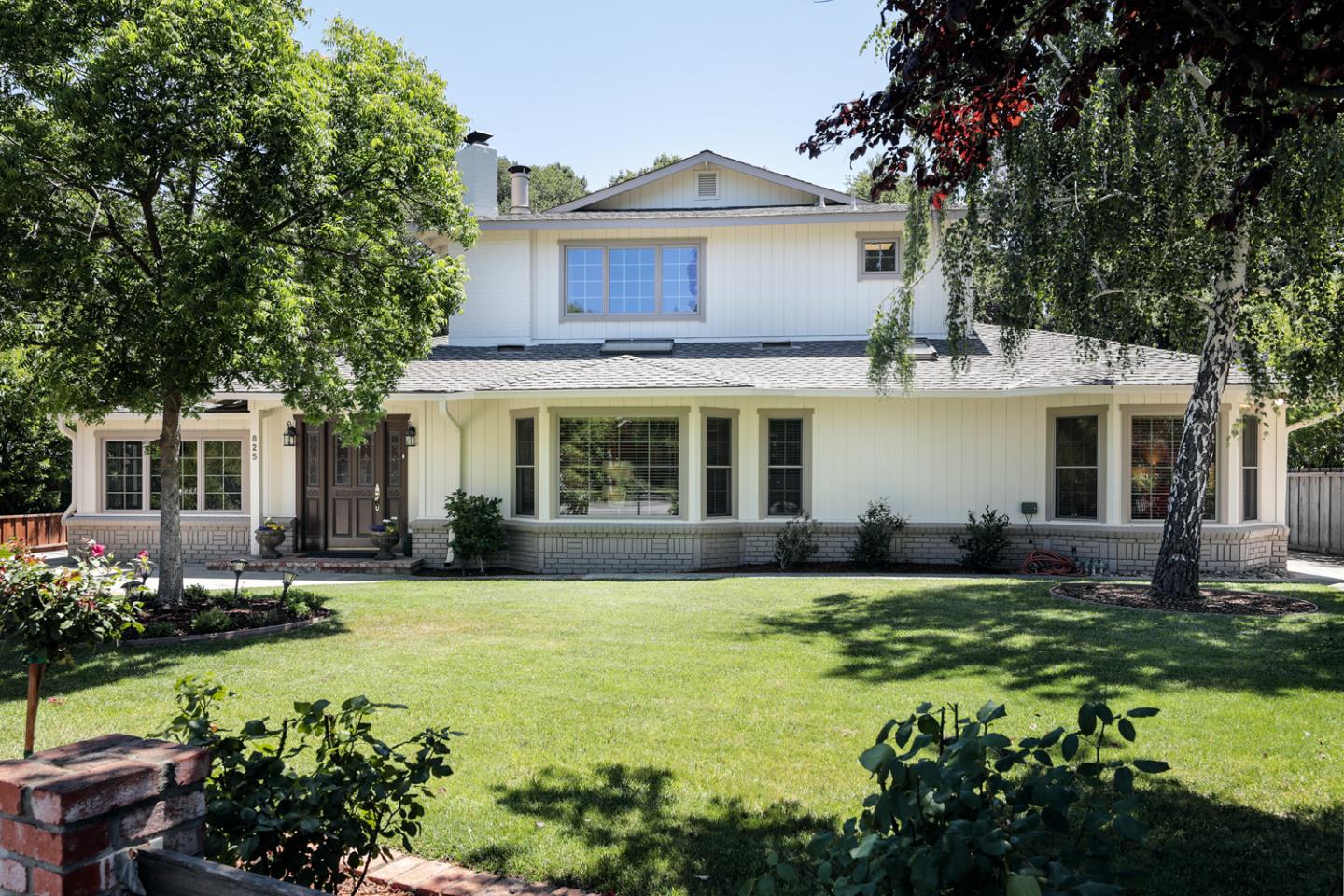 a front view of a house with a garden and porch