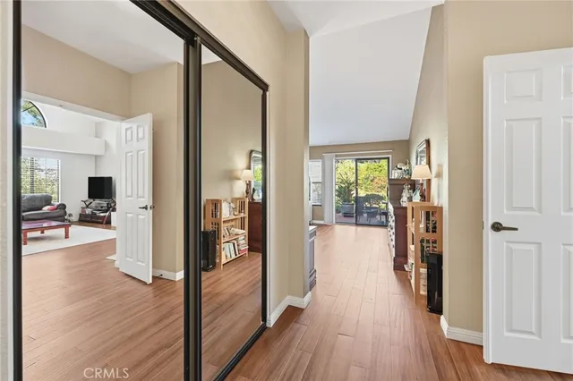a view of a hallway view with wooden floor and living room